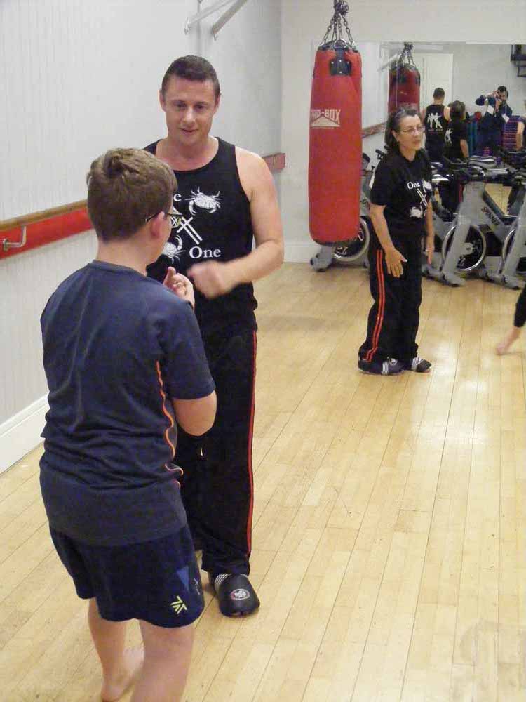 A picture of a younger student iacting out a routine with an older partner